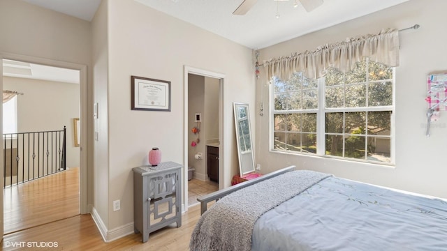 bedroom featuring connected bathroom and hardwood / wood-style floors