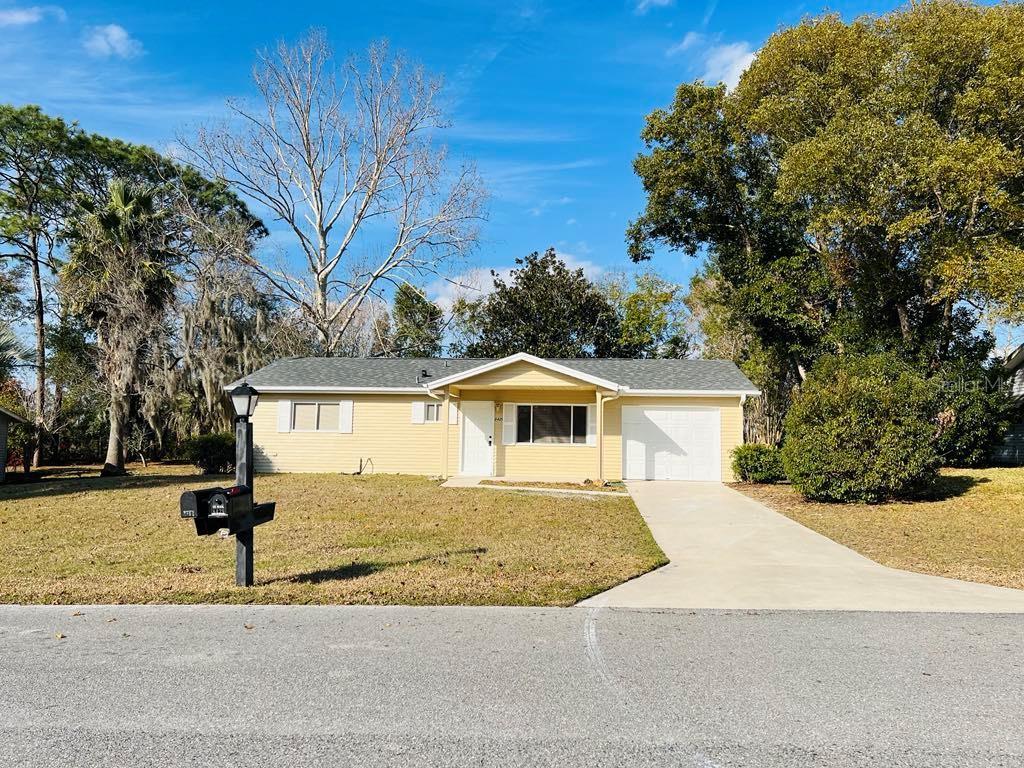 ranch-style home with a front yard and a garage