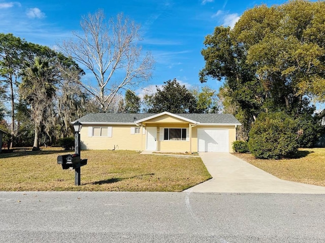 ranch-style home with a front yard and a garage