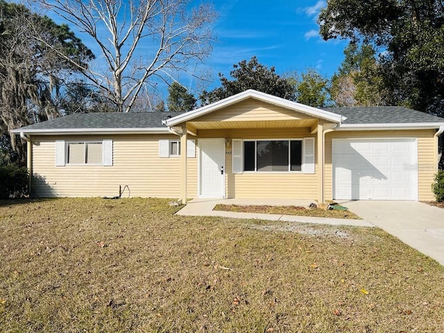 ranch-style house featuring a garage and a front lawn