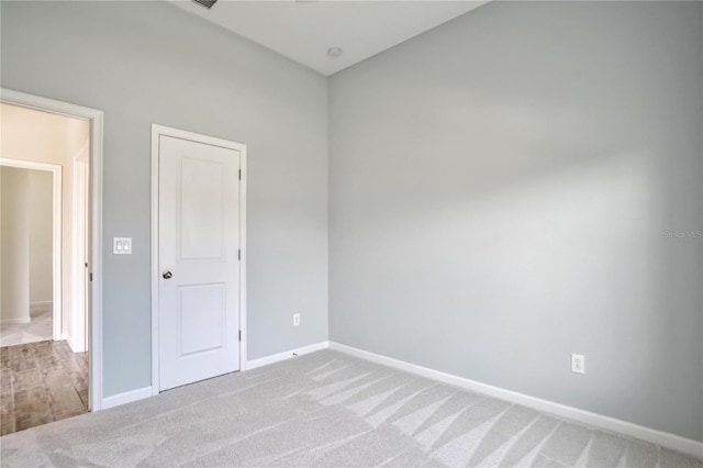 empty room featuring light carpet