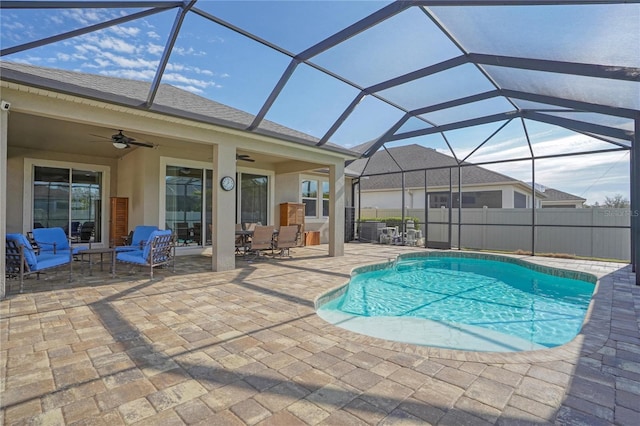 view of pool featuring ceiling fan, a lanai, and a patio