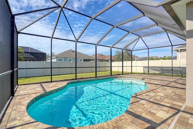 view of pool with a yard, a lanai, and a patio area