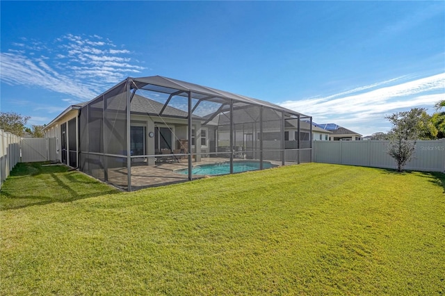 rear view of property with a yard, a fenced in pool, a patio area, and a lanai