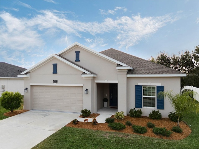 ranch-style home with a garage, concrete driveway, a shingled roof, and stucco siding