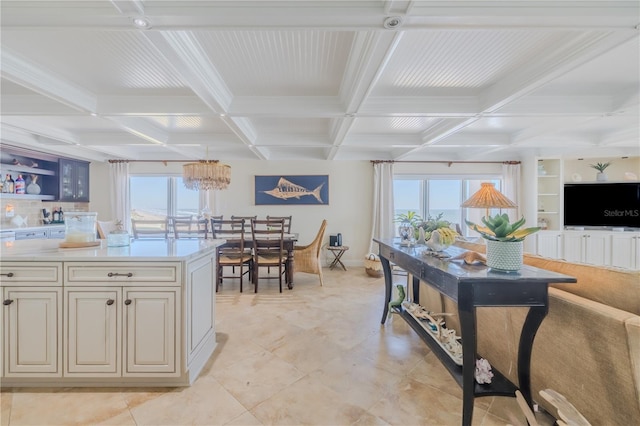 interior space with built in shelves, plenty of natural light, beamed ceiling, and coffered ceiling