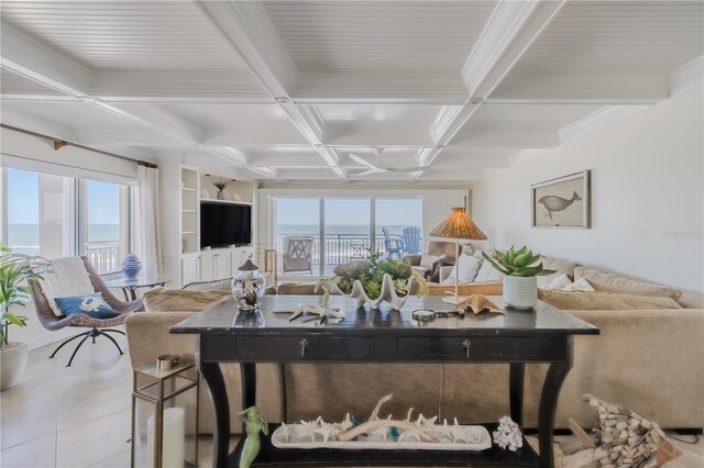 tiled living room with a water view, built in features, beamed ceiling, and coffered ceiling