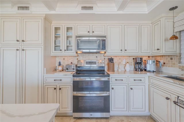 kitchen with decorative light fixtures, ornamental molding, appliances with stainless steel finishes, and tasteful backsplash