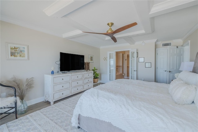 bedroom featuring ceiling fan, light wood-type flooring, and crown molding