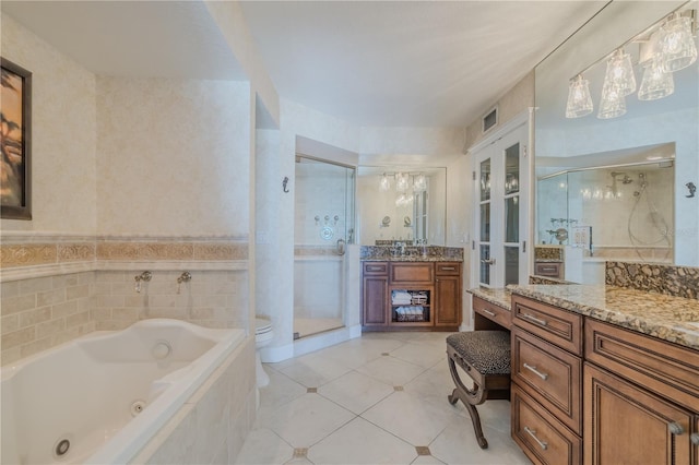 bathroom featuring tile patterned floors, plus walk in shower, and vanity