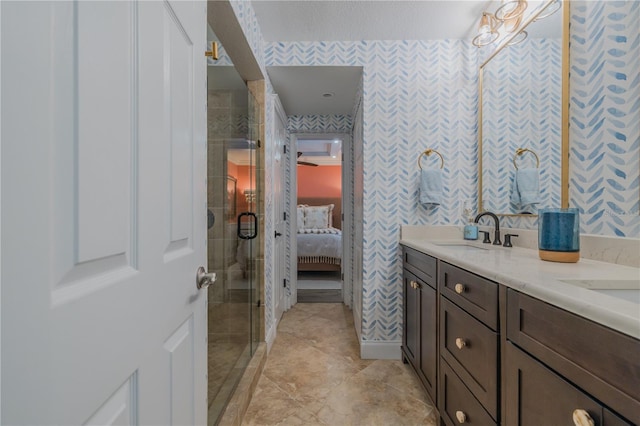 bathroom featuring vanity and a shower with door