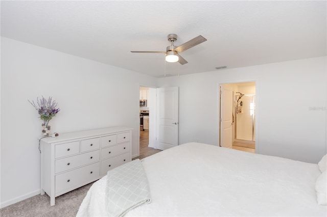 bedroom with ensuite bath, ceiling fan, and light colored carpet