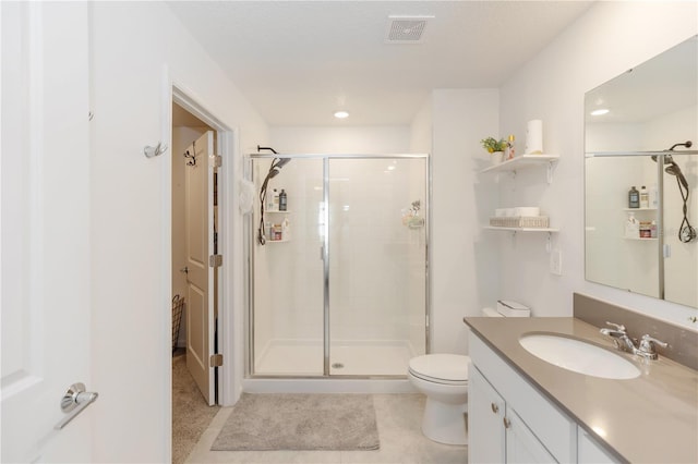 bathroom with tile patterned flooring, vanity, toilet, and an enclosed shower