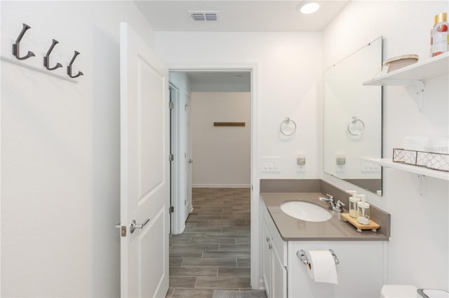 bathroom featuring vanity and toilet