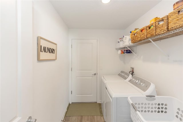 clothes washing area with independent washer and dryer