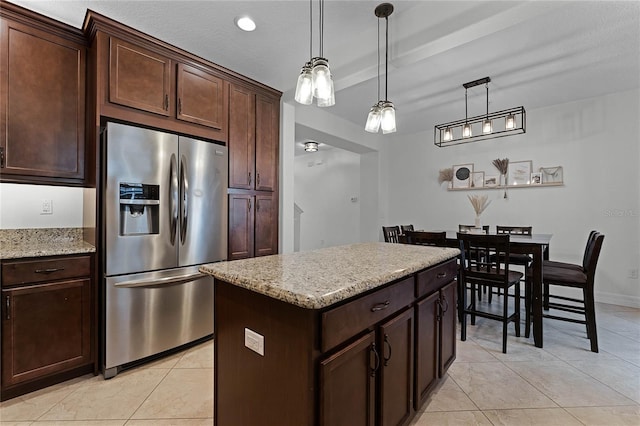 kitchen with dark brown cabinetry, a kitchen island, decorative light fixtures, and stainless steel refrigerator with ice dispenser