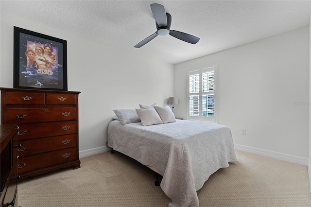 carpeted bedroom featuring a textured ceiling and ceiling fan