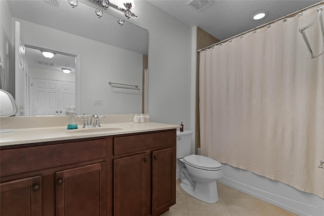 full bathroom with tile patterned floors, a textured ceiling, toilet, vanity, and shower / tub combo