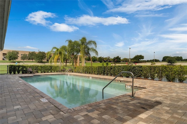 view of swimming pool with a patio