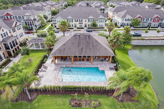 view of pool featuring a water view and a patio area