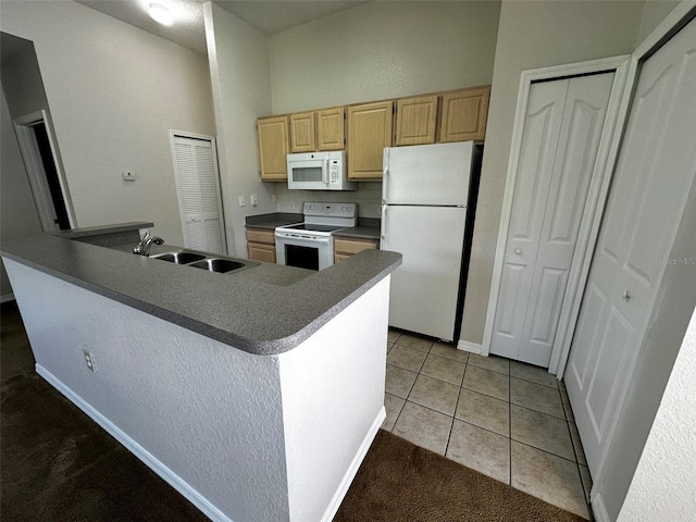 kitchen with light tile patterned floors, a center island, light brown cabinets, white appliances, and sink