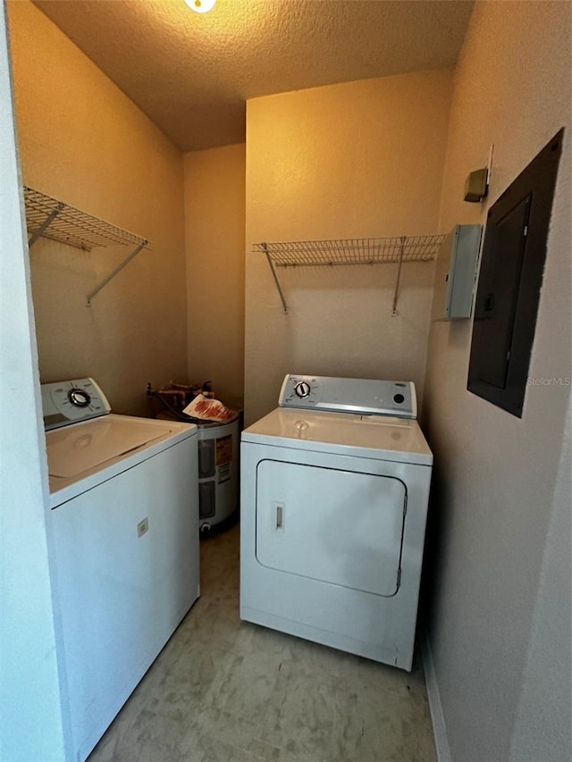 laundry room with a textured ceiling, electric panel, and independent washer and dryer