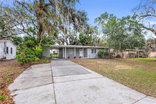 single story home featuring a carport and a front yard