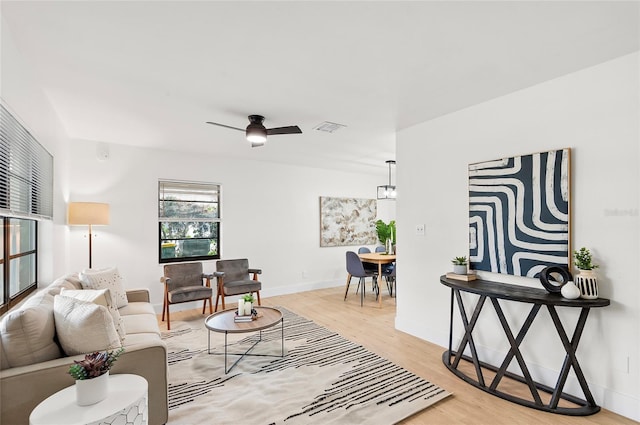 living room featuring light hardwood / wood-style floors and ceiling fan