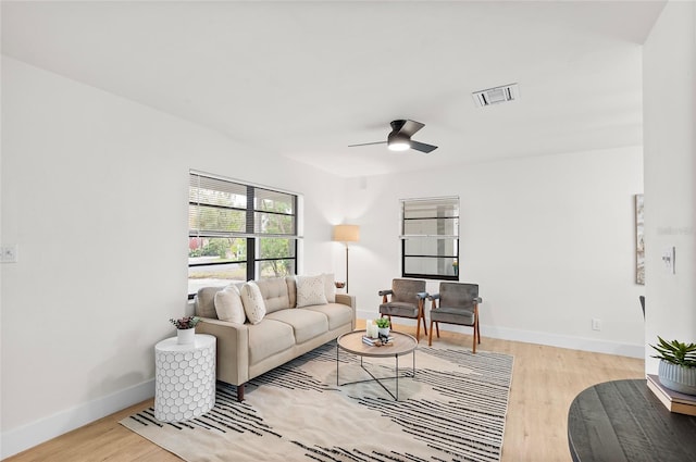 living room featuring ceiling fan and light hardwood / wood-style floors