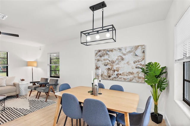 dining space featuring ceiling fan and light hardwood / wood-style flooring