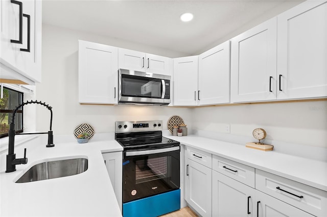 kitchen with white cabinetry, sink, and appliances with stainless steel finishes