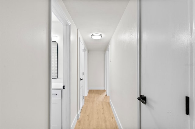 hallway with light hardwood / wood-style floors