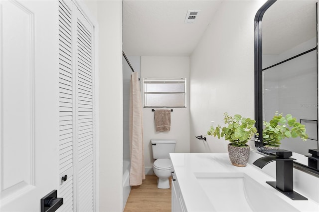 bathroom featuring hardwood / wood-style floors, vanity, and toilet