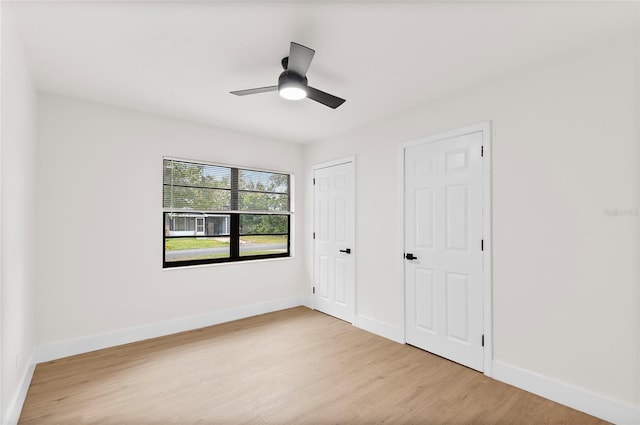 unfurnished bedroom with ceiling fan and light hardwood / wood-style floors