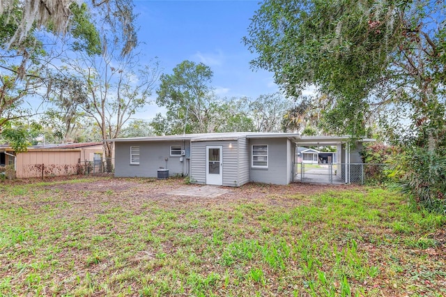 back of house with a carport