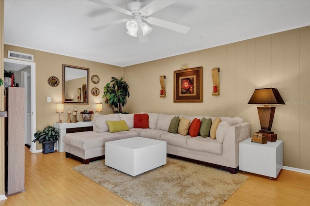 living room featuring hardwood / wood-style flooring and ceiling fan