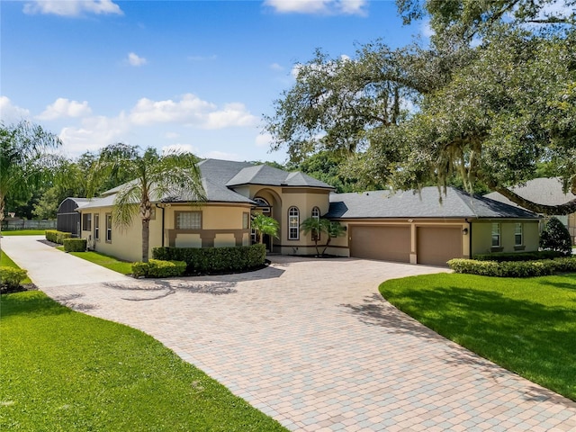 view of front facade with a front yard and a garage