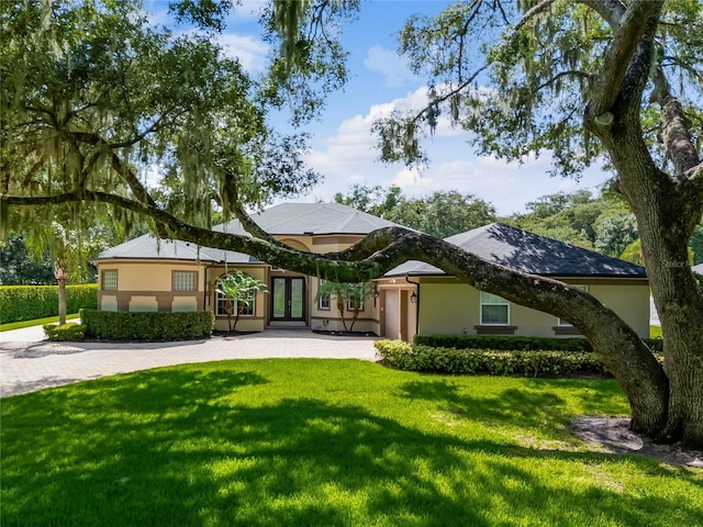 back of house with a yard and french doors