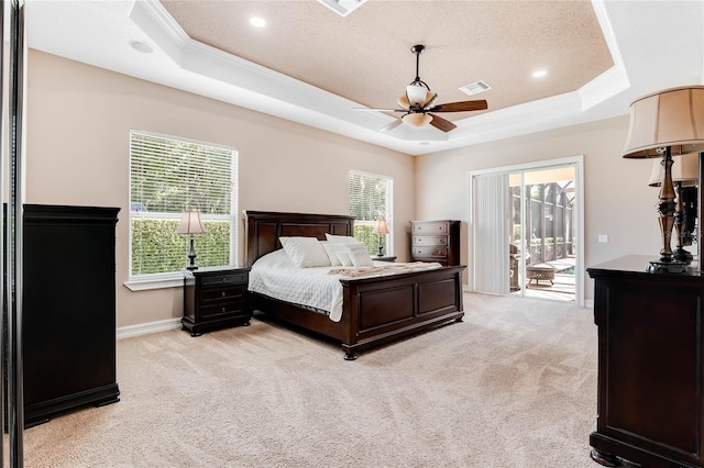 bedroom featuring light carpet, access to outside, a raised ceiling, and ceiling fan