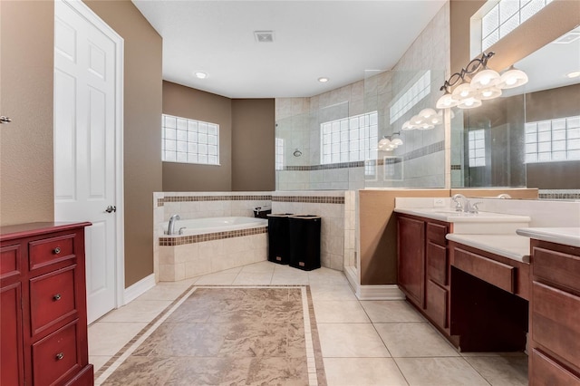 bathroom featuring tile patterned floors, vanity, and shower with separate bathtub