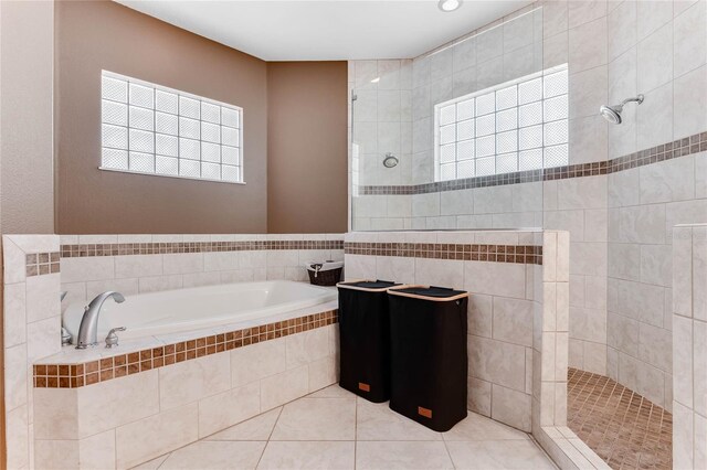 bathroom featuring tile patterned flooring and separate shower and tub