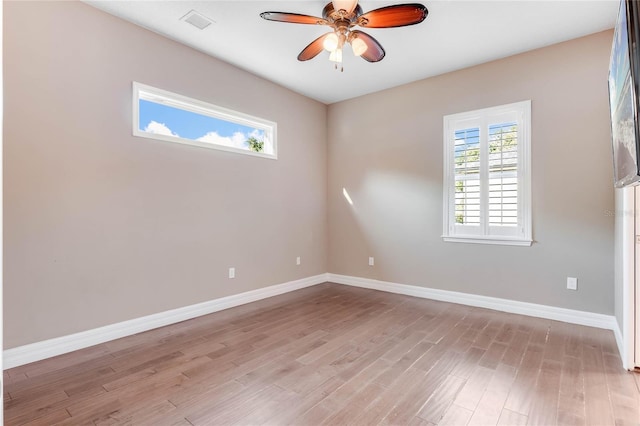 spare room featuring light wood-type flooring and ceiling fan