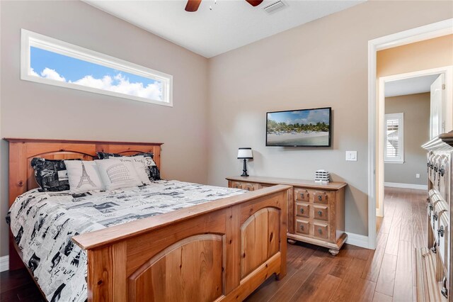 bedroom with ceiling fan and dark hardwood / wood-style flooring