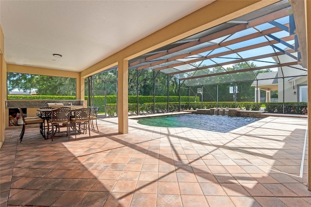 view of pool featuring glass enclosure, pool water feature, and a patio