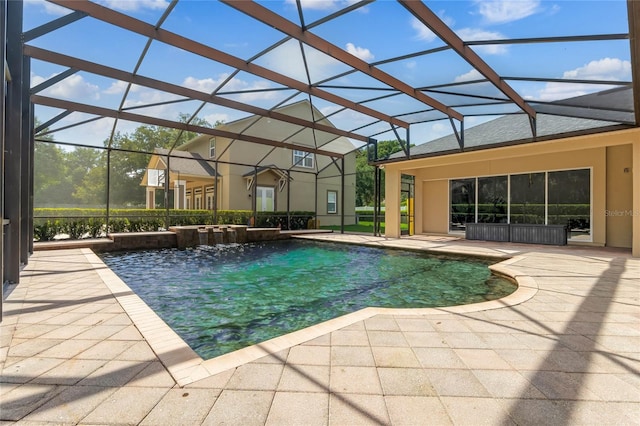 view of swimming pool with pool water feature, glass enclosure, and a patio