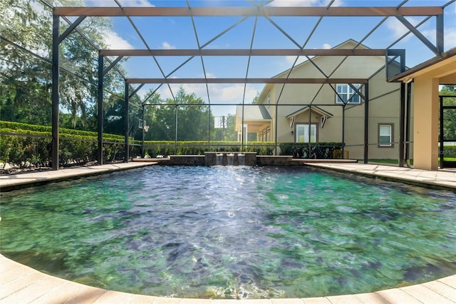 view of pool with glass enclosure and pool water feature