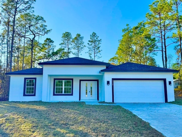 view of front of home featuring a front yard and a garage