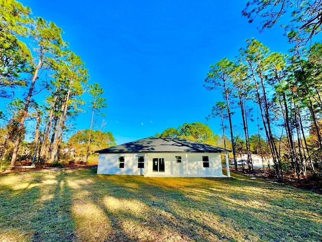 rear view of house with a lawn