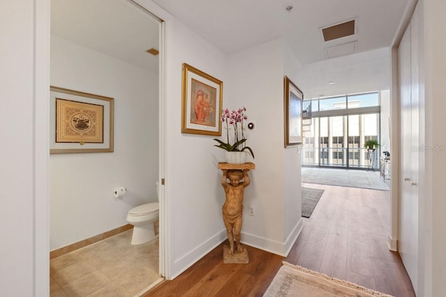 hallway with light hardwood / wood-style flooring