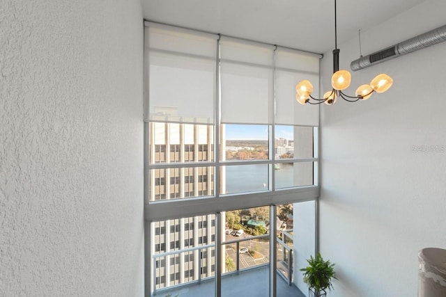 interior details featuring an inviting chandelier